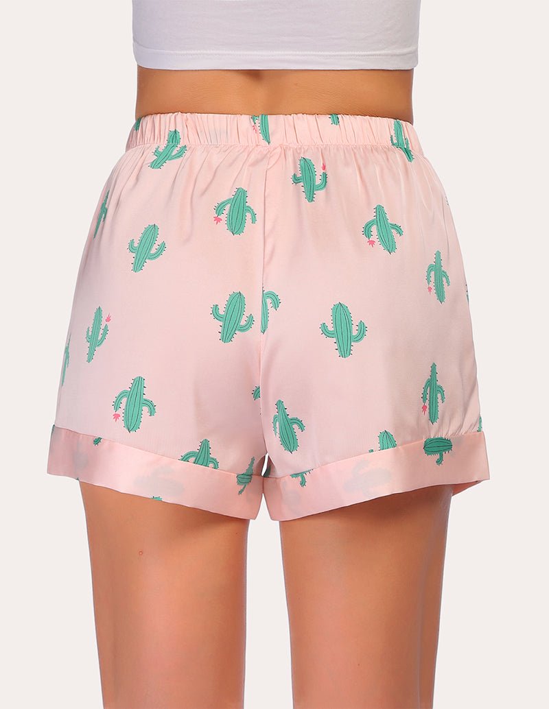 Loose pajama shorts in light pink with green cactus print, elastic waistband, side view.