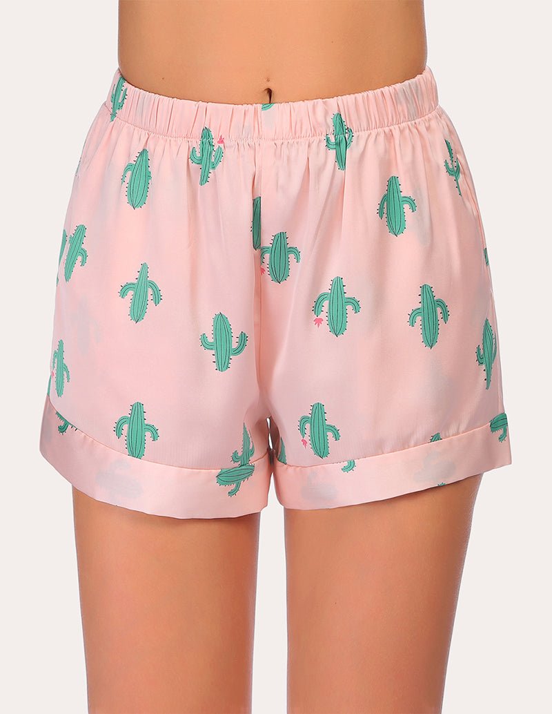 Loose pajama shorts in light pink with green cactus print and elastic waistband.
