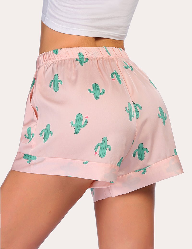 Loose pajama shorts in light pink with green cactus print and elastic waistband, back view.