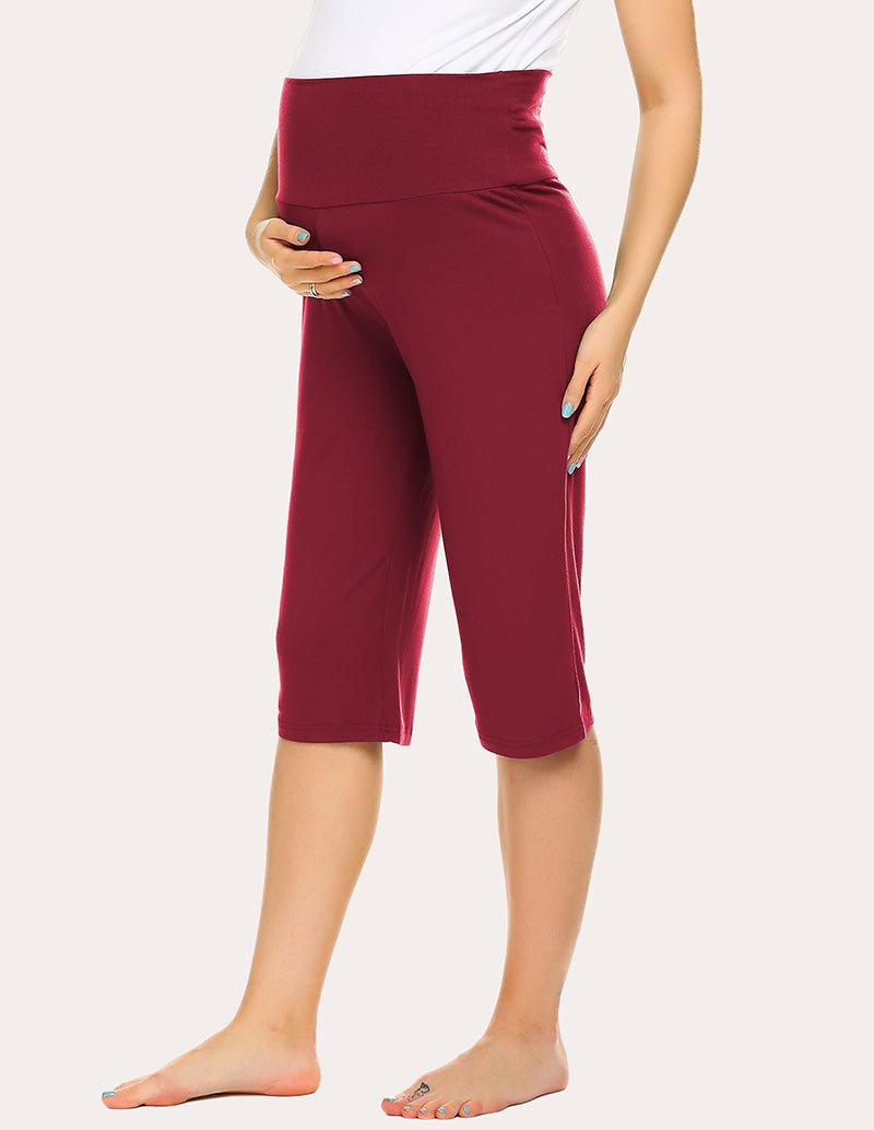 Wine red maternity capri pants with belly panel, angled front view