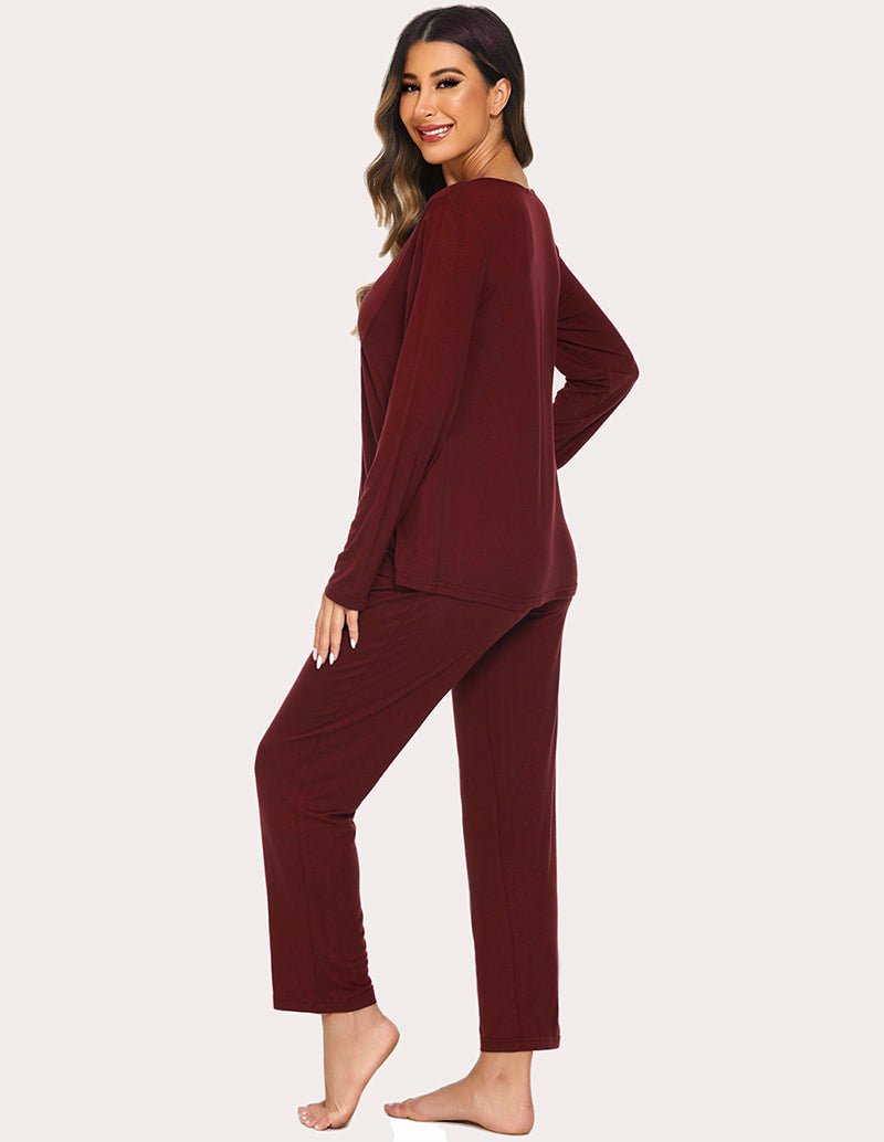 Wine red maternity top and ankle pants set, side view with long sleeves and draped fit