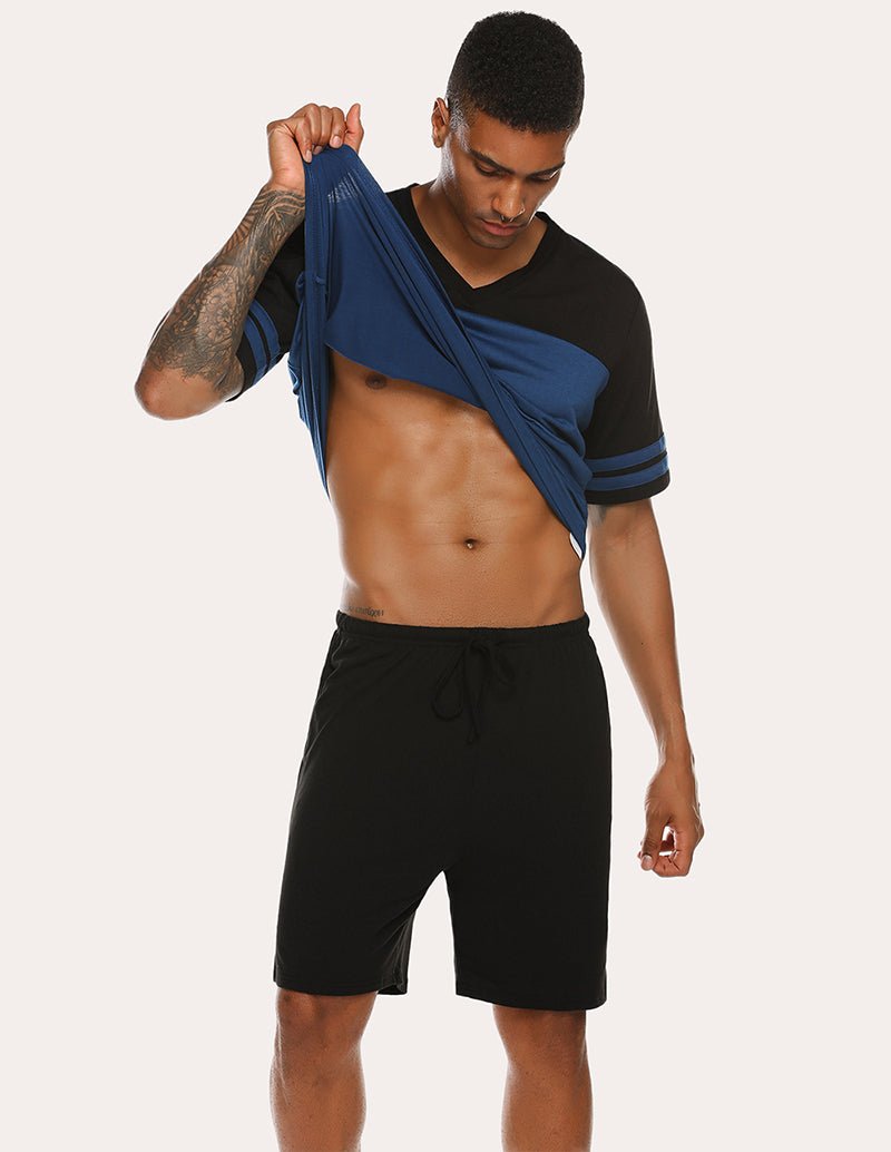 Men's contrast pajama set with navy top draped over shoulder and black shorts