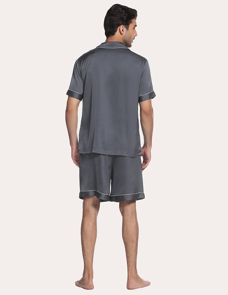 Dark blue men’s satin pajama set, back view of short-sleeve button shirt and knee-length shorts