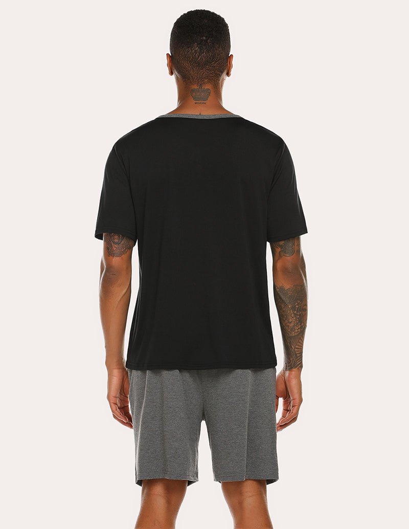 Men's black short-sleeve pajama top and gray drawstring shorts, back view
