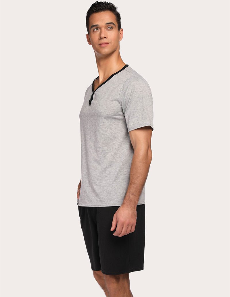Men's gray short-sleeve pajama top with black drawstring shorts set, side view