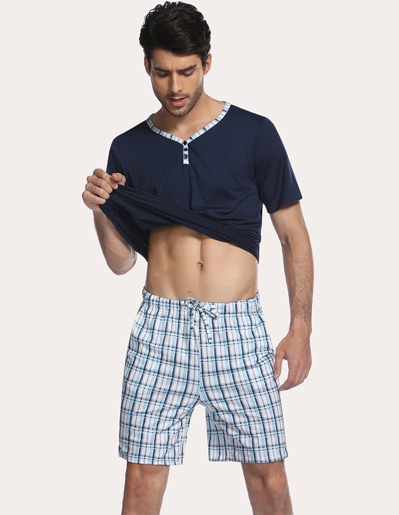 Men's navy henley pajama top with blue plaid drawstring sleep shorts, front view
