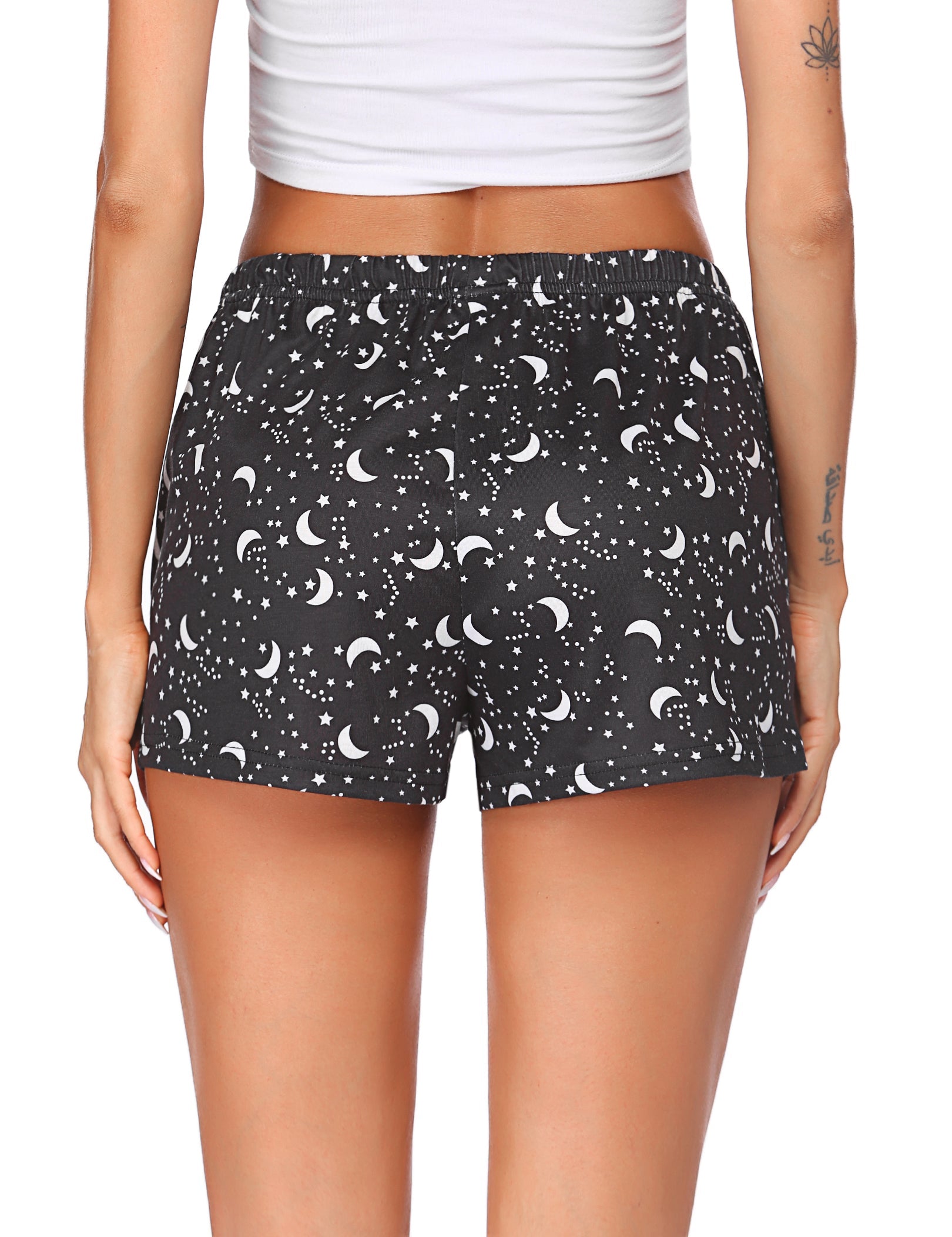 Black pajama shorts with repeated moons and stars, elastic waistband with gathered top