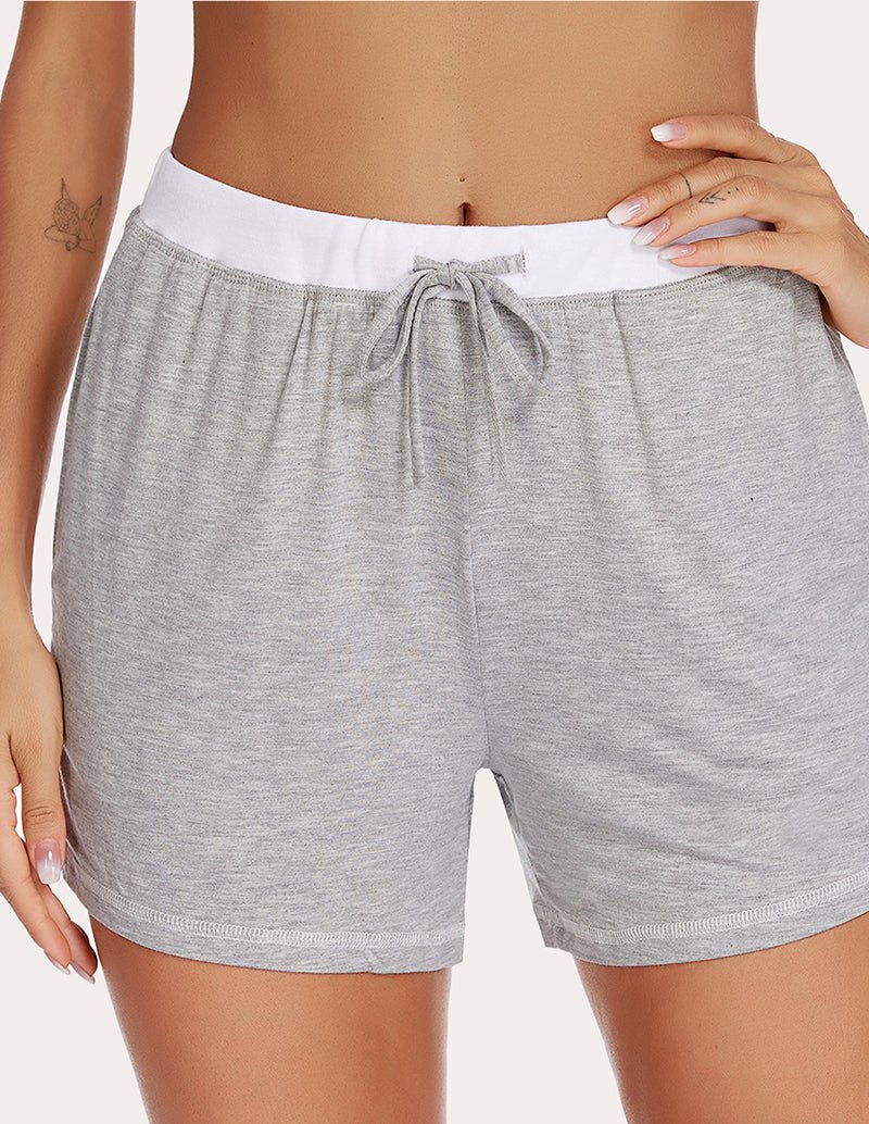 Light grey pajama shorts with white waistband and tied drawstring at front