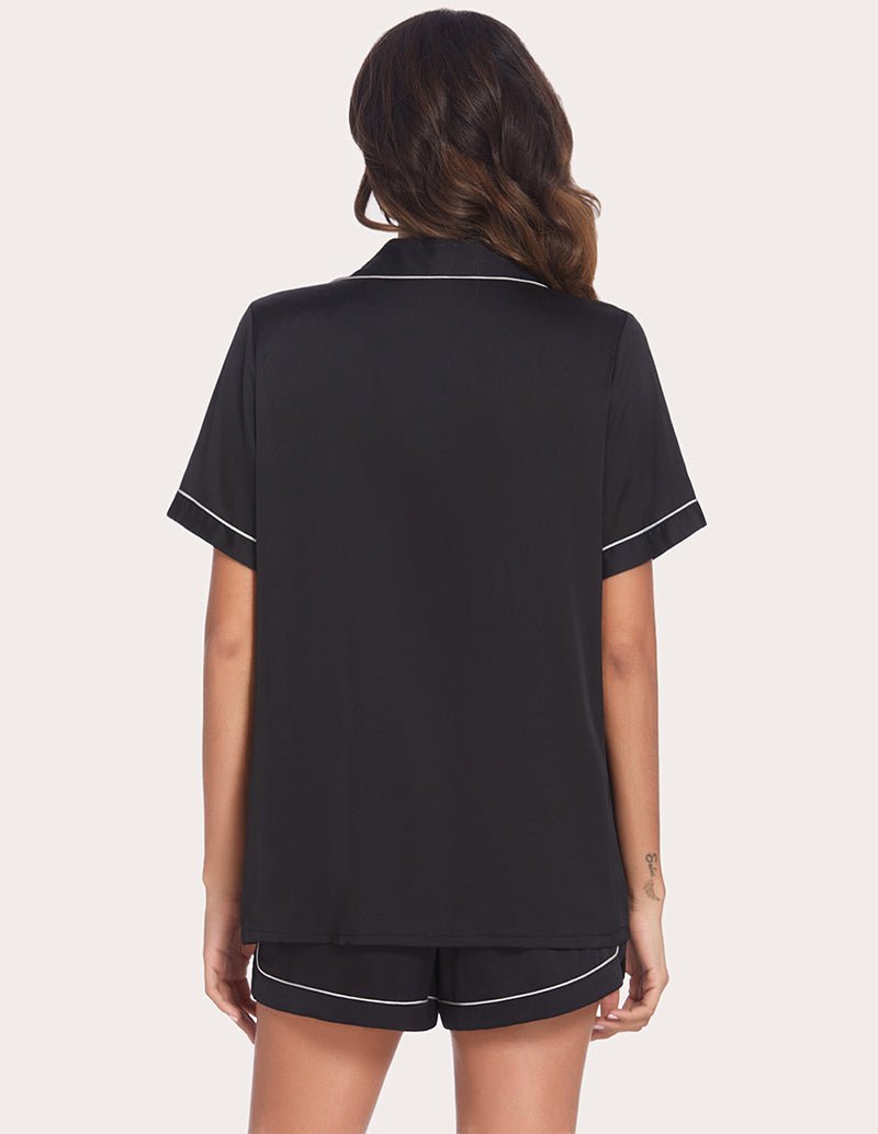 Black piping pajama set, back view of button-front top and matching shorts