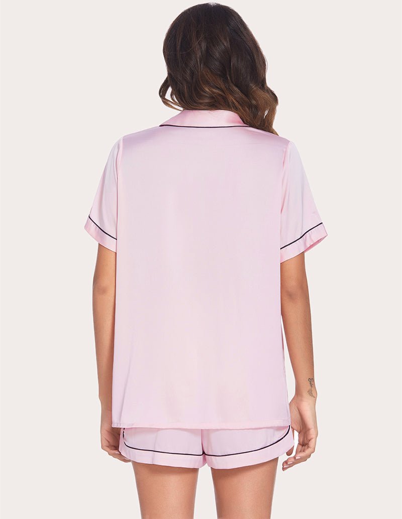 Women's pink pajama set, short-sleeve button top and matching shorts from the back