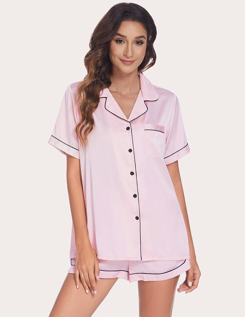 Women's pink pajama set with contrast piping, button-front shirt and drawstring shorts
