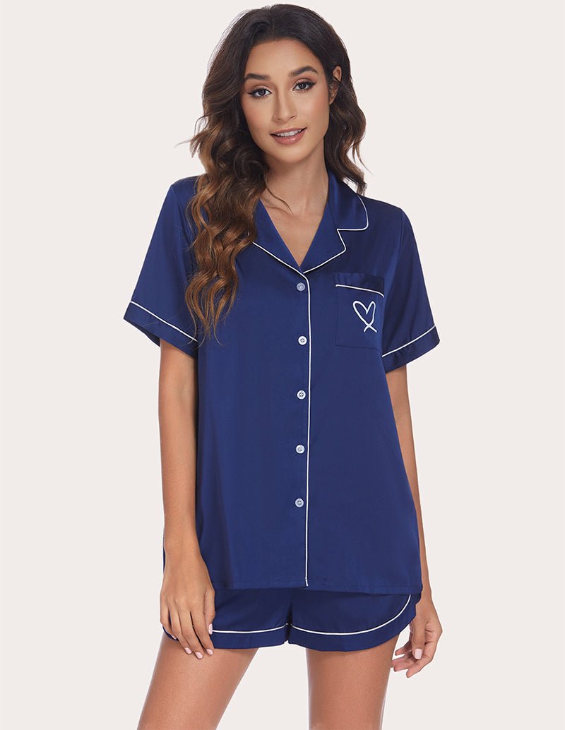 Women's navy pajama set with contrast piping, button-front top and drawstring waist shorts