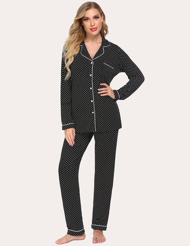 Women’s pajama set with dark navy fabric and white dot print, button-up top and pants