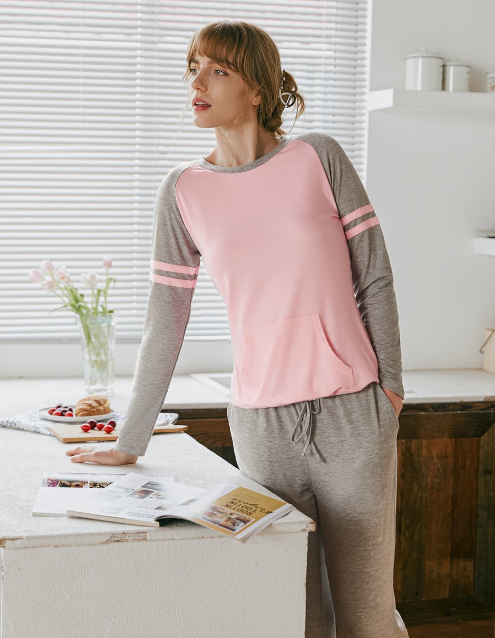 Raglan sleeve pajama set with pink top and gray drawstring joggers, front view.