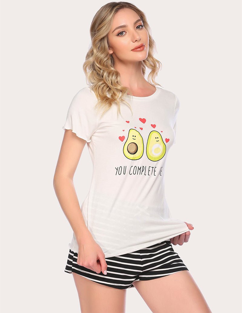 White pajama set with avocado heart graphic T-shirt and striped shorts, side pose