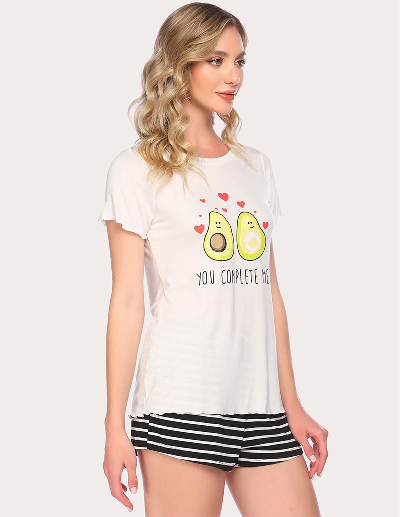 White pajama set with avocado heart graphic T-shirt and striped shorts, profile view