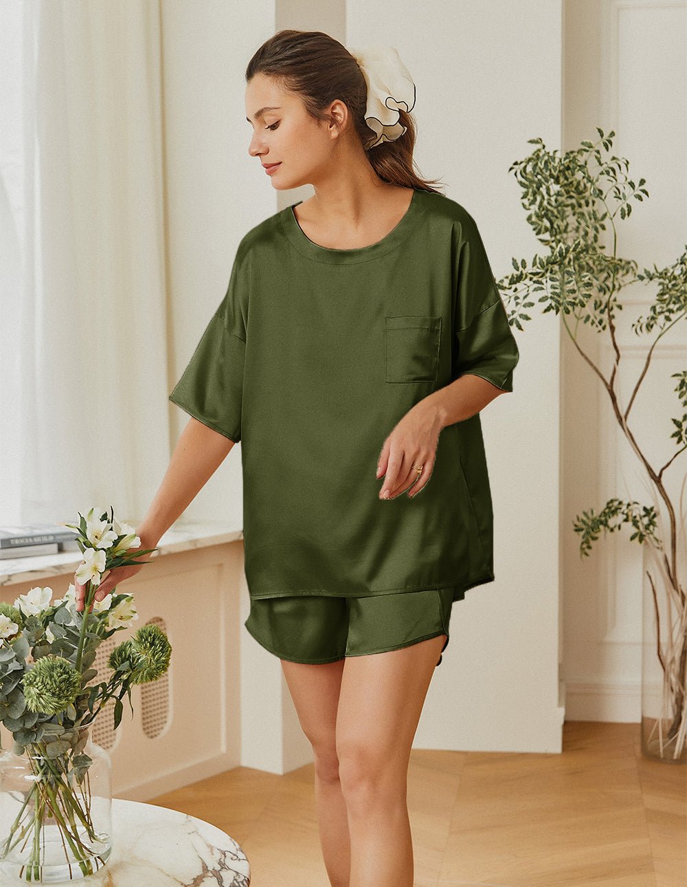 Green satin pajama set with short-sleeve top and matching elastic-waist sleep shorts