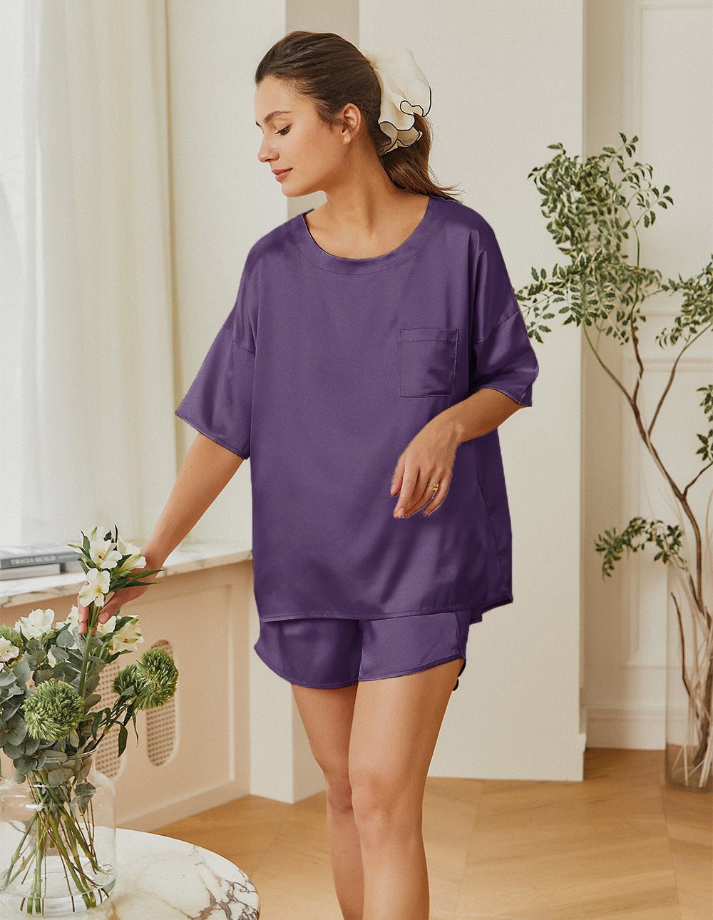 Purple satin pajama set with short-sleeve top and matching elastic-waist sleep shorts