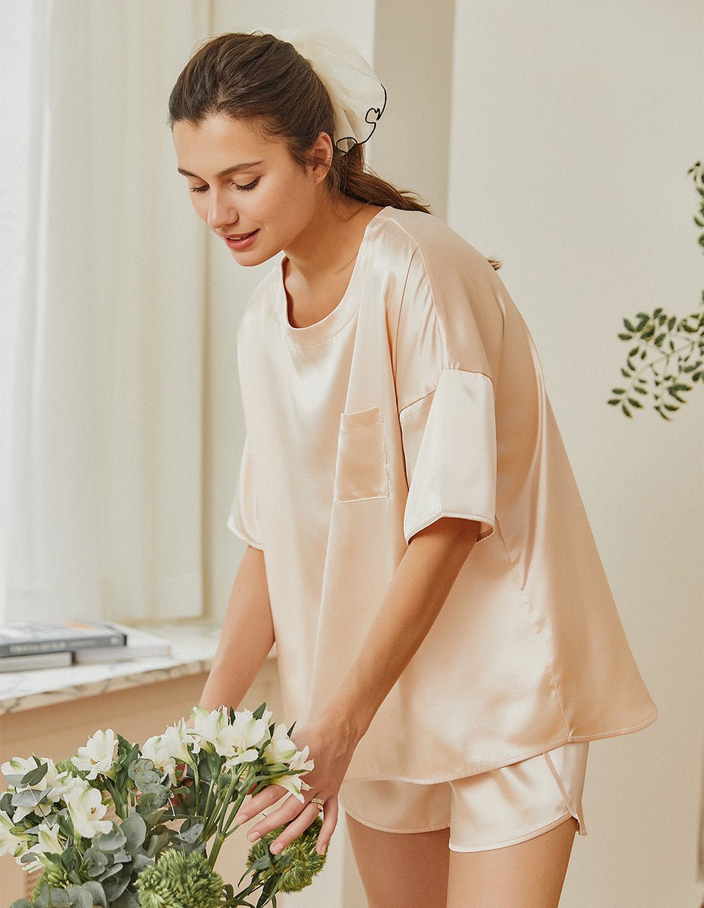 Champagne satin pajama set, side view: chest pocket top with relaxed-fit shorts