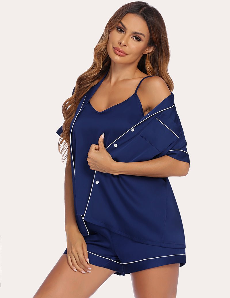Navy satin pajama set with cami and matching shorts, shirt draped over shoulders
