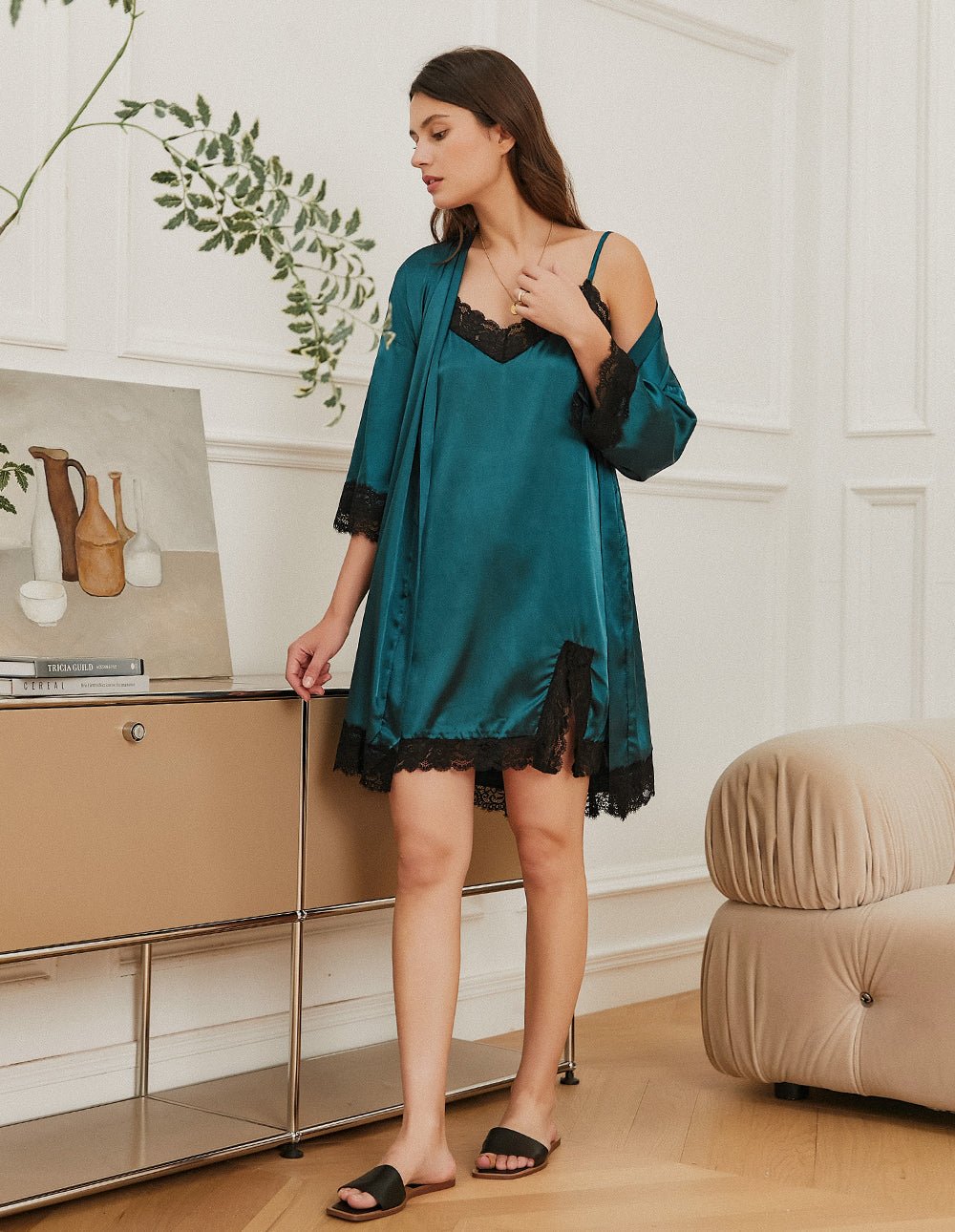 Dark green satin nightdress with black lace hem, V-neckline, and thin straps