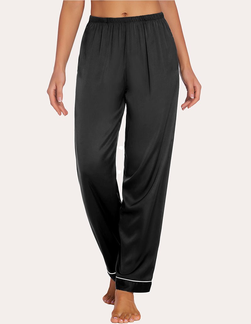 Black satin pajama pants with elastic waistband and contrast piping at cuffs