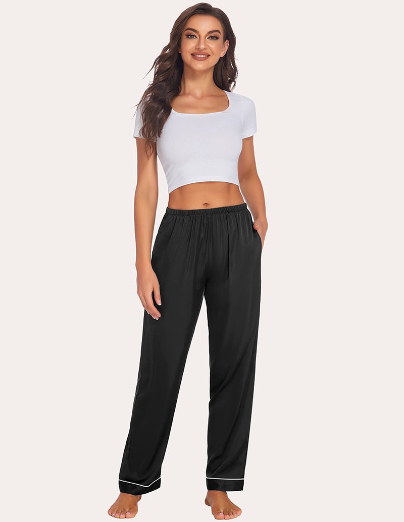 Black satin pajama pants with elastic waistband and contrast piping along cuffs