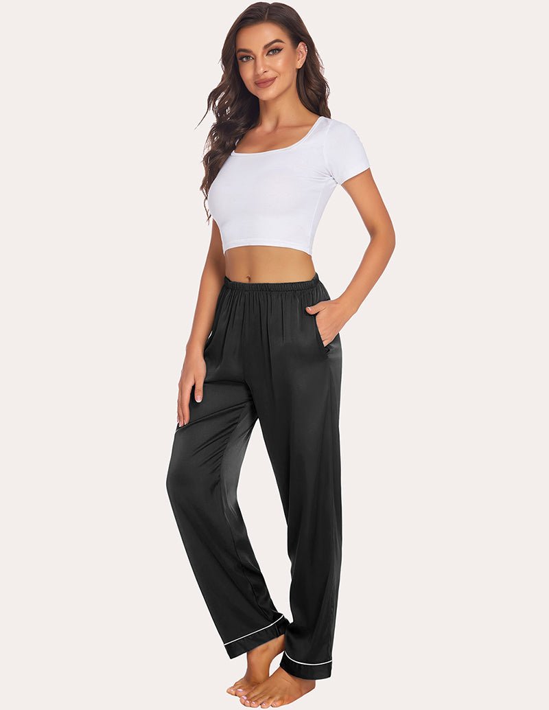 Black satin pajama pants with elastic waist and contrast cuff piping, relaxed fit