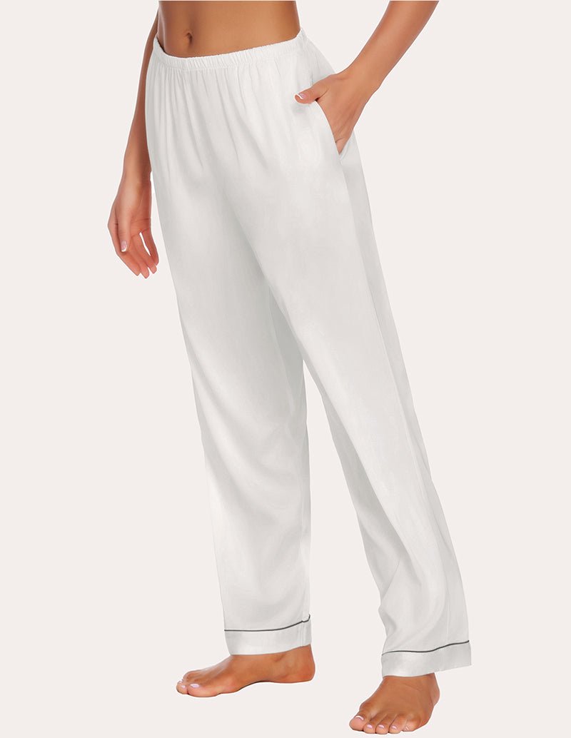 White satin pajama pants with elastic waist, loose straight legs, and cuffed ankle hem.