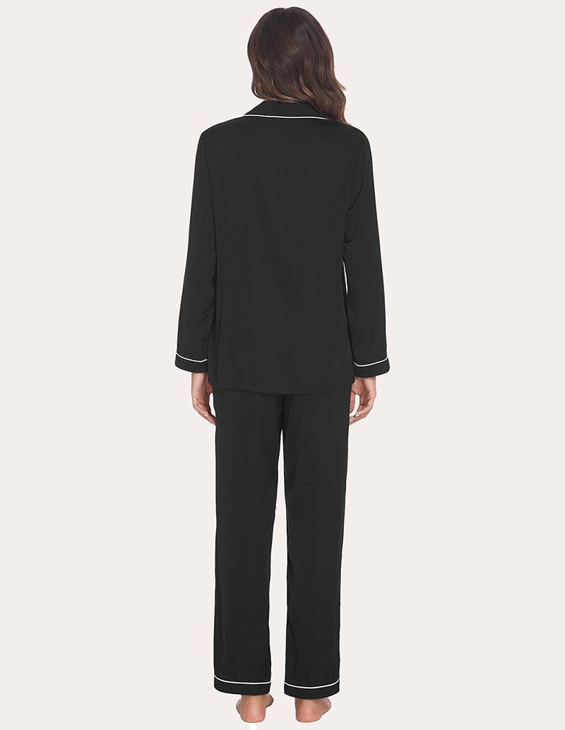 Back view: black satin long-sleeve pajama top and pants with contrast piping