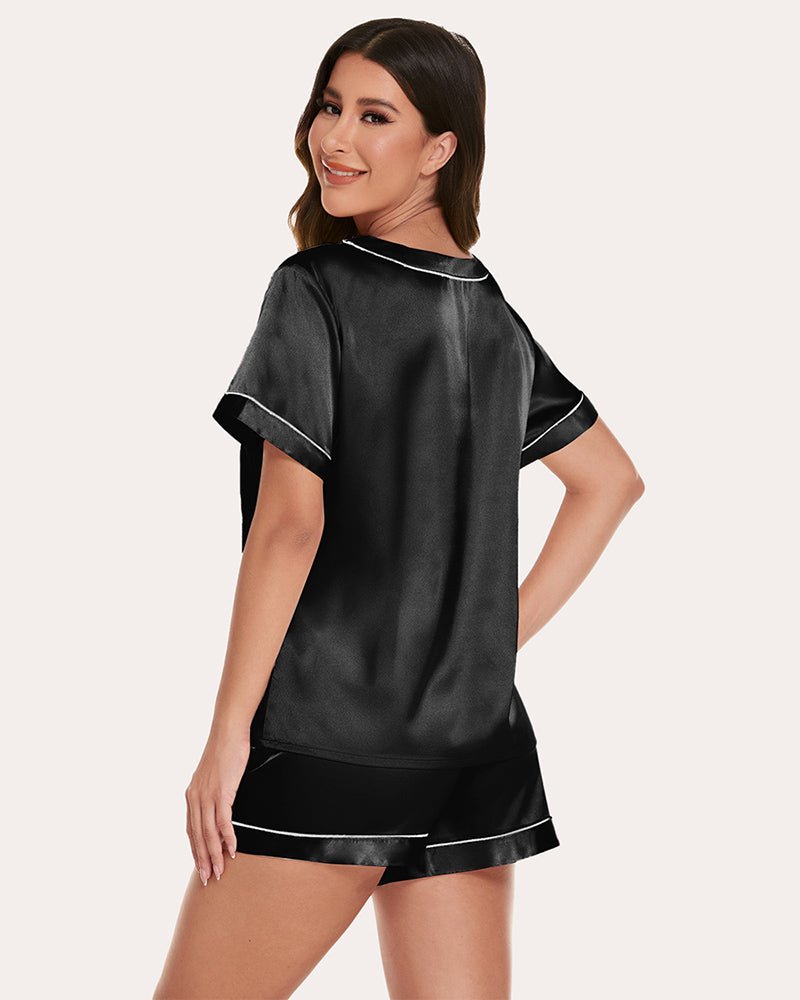 Black satin short-sleeve pajama set with contrast piping and matching drawstring shorts