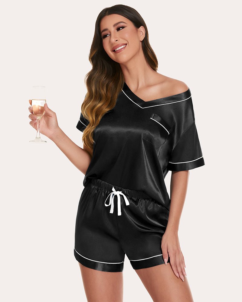 Black satin pajama set with short sleeves, contrast piping, drawstring waist shorts