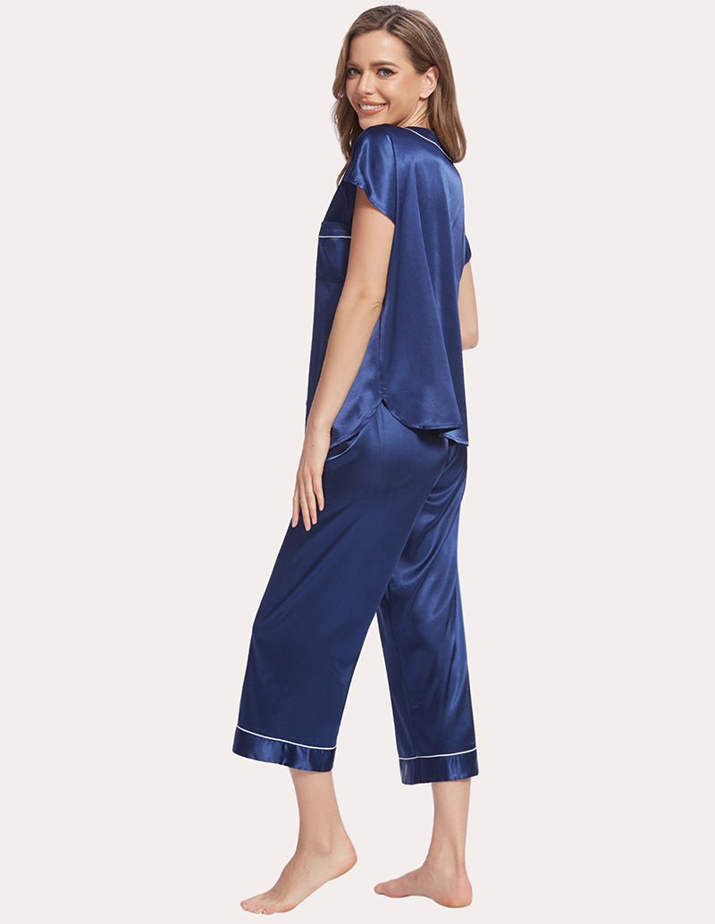 Navy blue satin pajama set, short-sleeve top and cropped leg pants with contrast trim