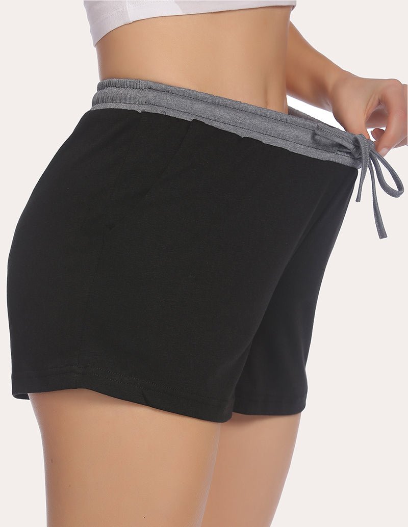 Black pajama shorts with gray waistband and tied drawstring, angled side view
