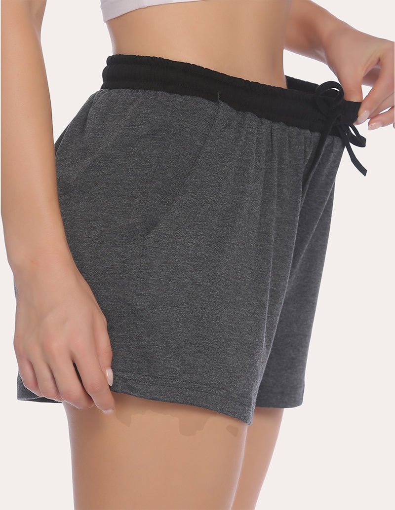 Dark heather gray pajama shorts with black waistband and tied drawstring, side view