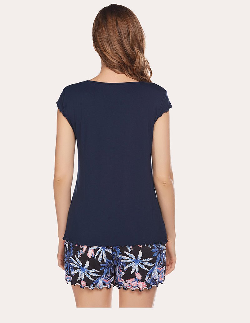 Back view: navy T-shirt with short sleeves and floral printed boxer-style shorts