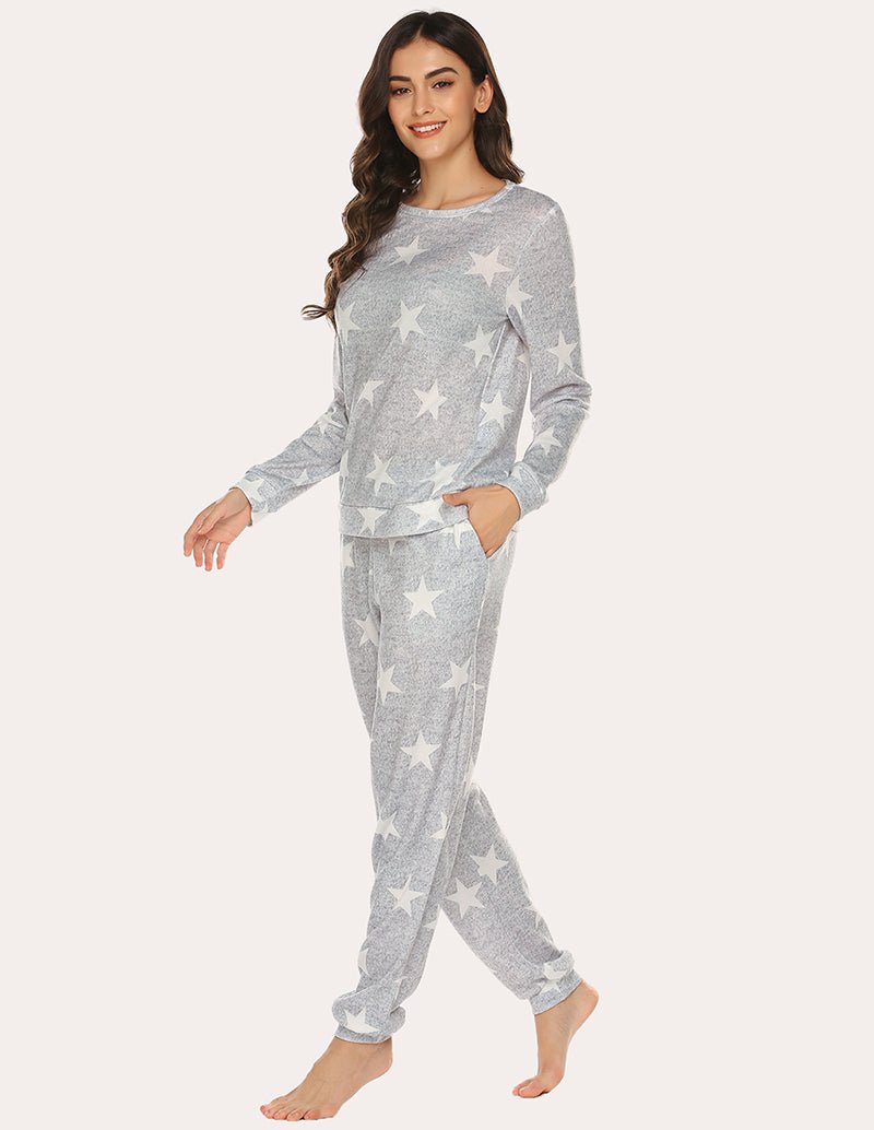Gray pajama set with white stars, relaxed long-sleeve top and tapered cuffed pants