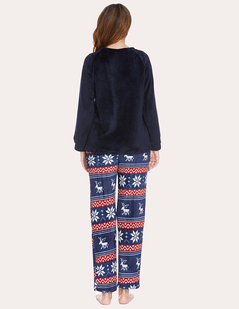 Women's fleece pajama set, back view: navy long-sleeve top with reindeer pants