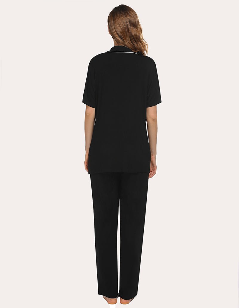 Back view: black short-sleeve pajama top and long pants with contrast piping