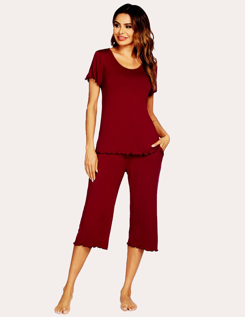 Wine red pajama set with short-sleeve top and cropped wide-leg pants, side front view.