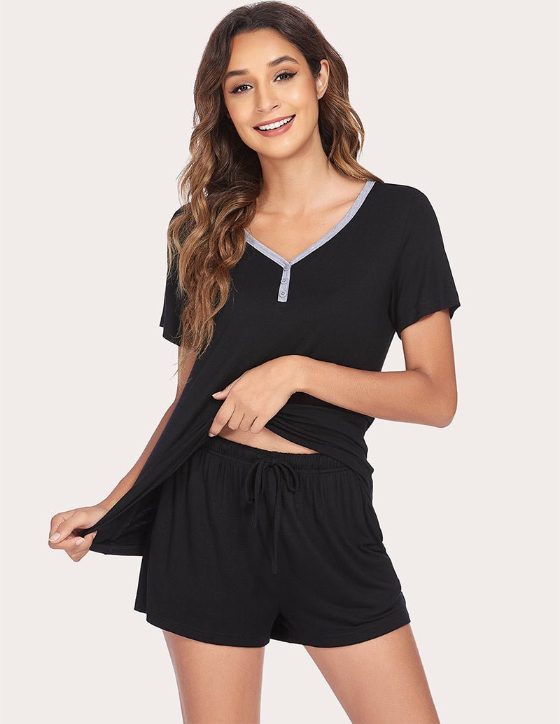 Black pajama set with V-neck top and drawstring shorts, side view