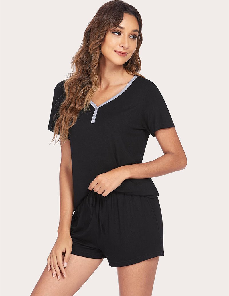 Black pajama set with V-neck top and drawstring waist shorts, angled view