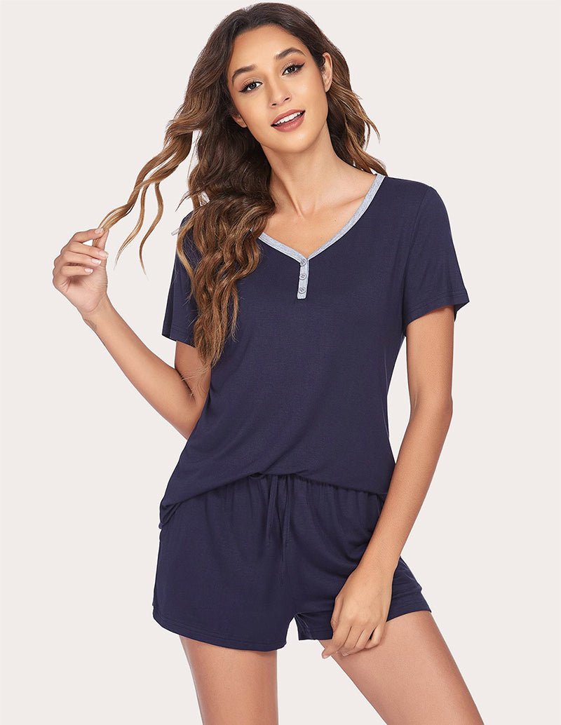 Navy blue pajama top with V-neck and contrast trim, paired with drawstring shorts