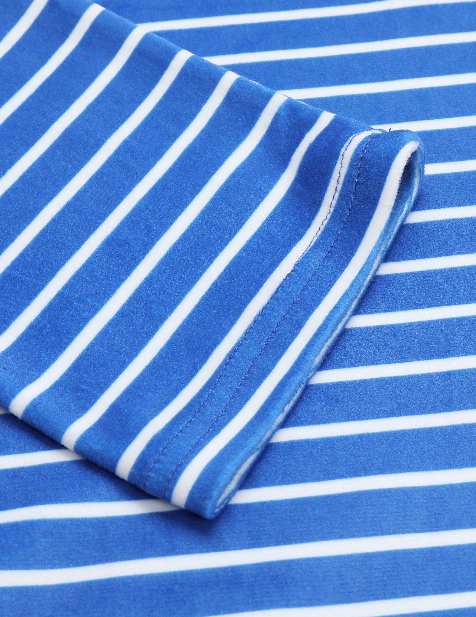 Velour pajama fabric swatch with blue base and white horizontal stripes