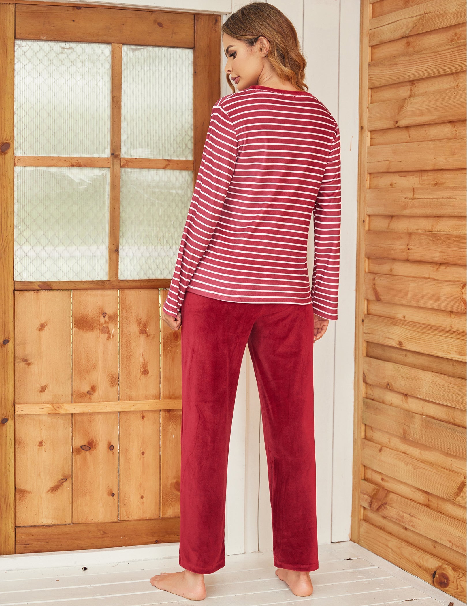Velour pajama set with red-and-white striped long-sleeve top and red long pants, back view