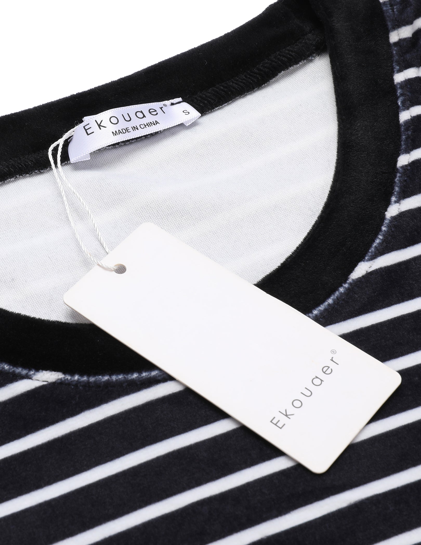 Velour pajama top neckline with brand tag on black-and-white striped fabric