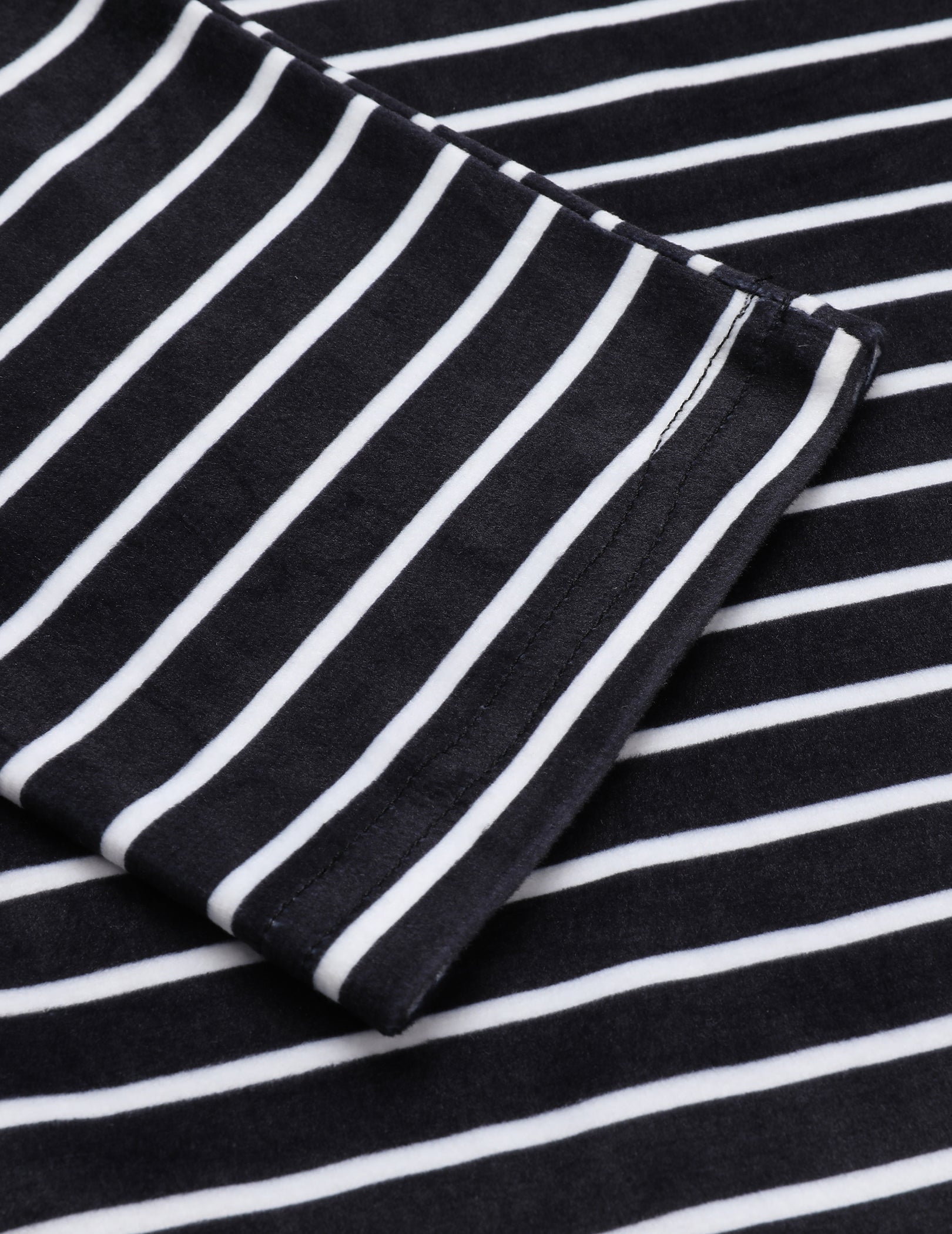 Black and white striped velour fabric detail on pajama sleeve and cuff