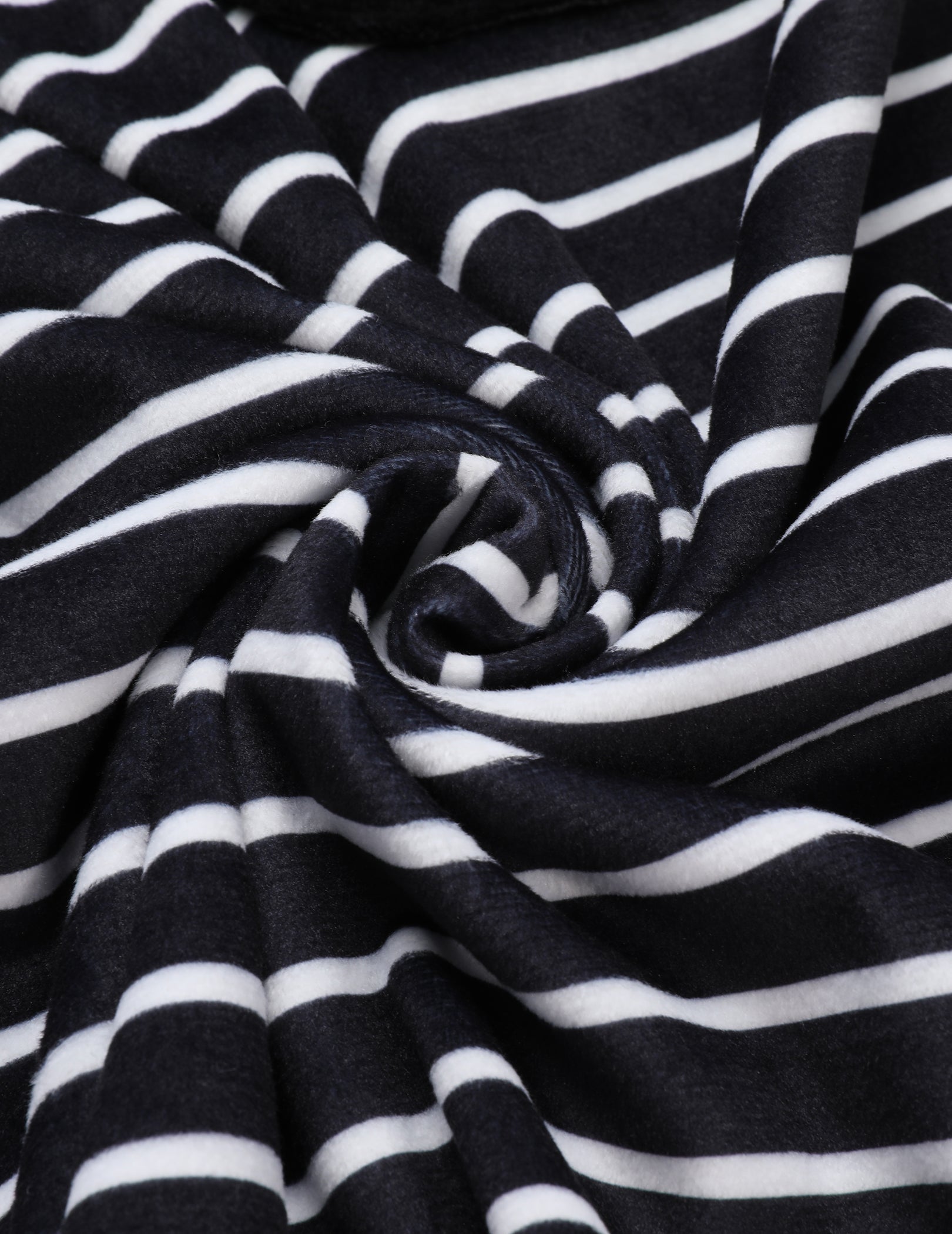 Black and white striped velour fabric close-up with soft drape