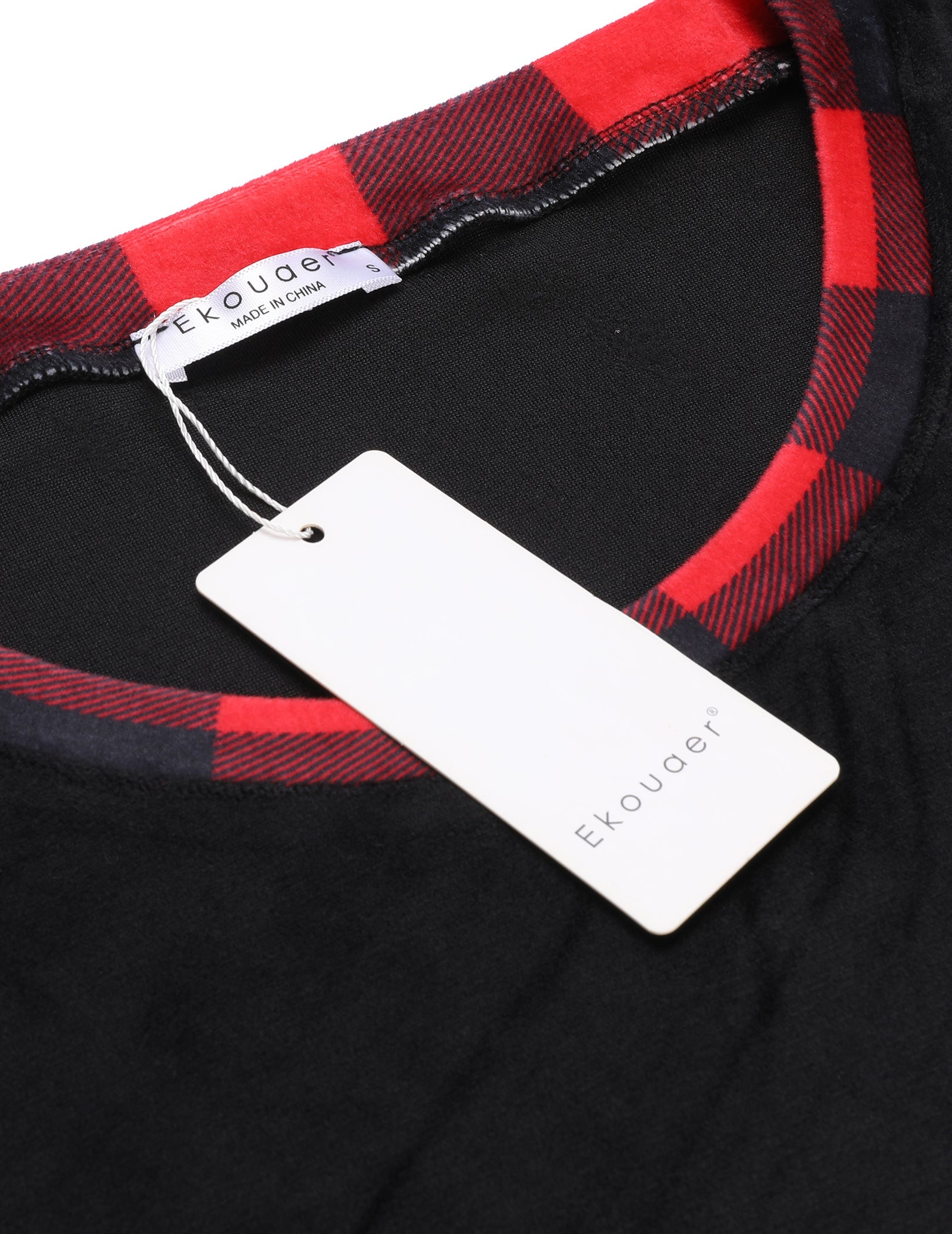 Black velour pajama top neckline with red and black plaid trim, brand tag attached