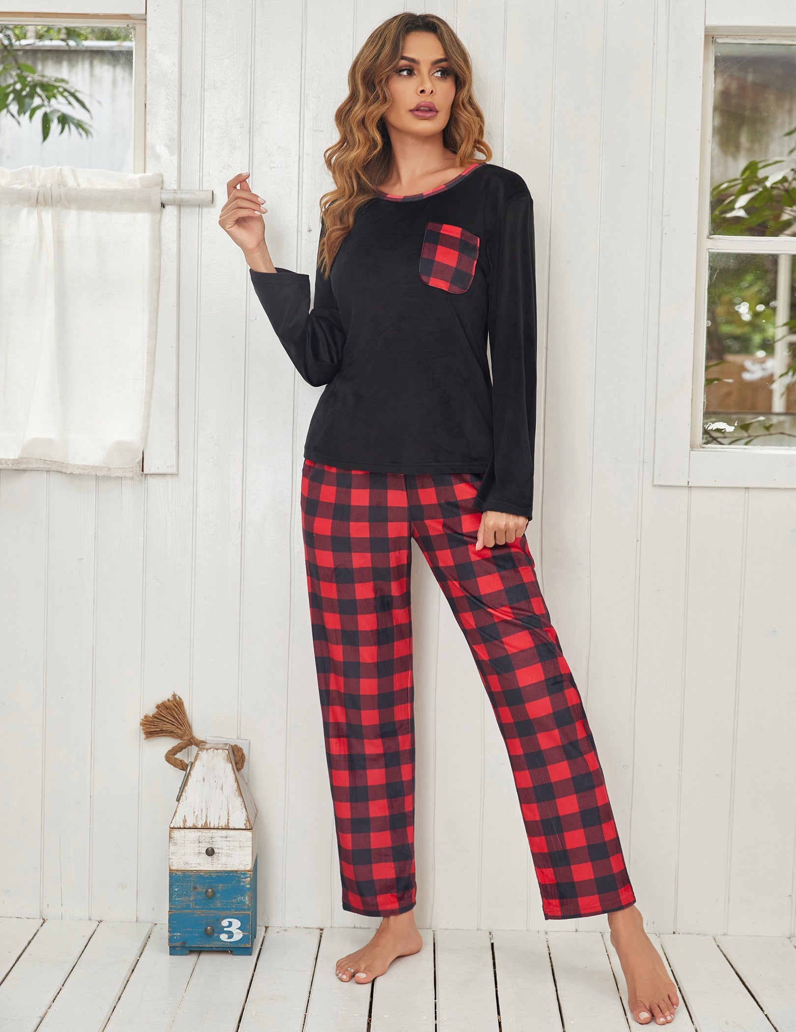 Black velour long-sleeve pajama set with red plaid pants, full view